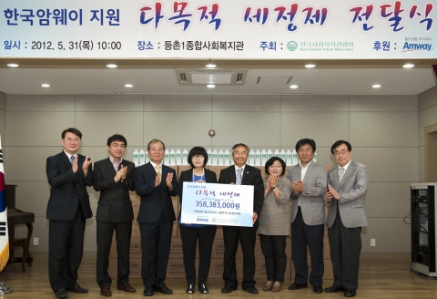 한국암웨이는 한국사회복지관협회와 함께 전국 2만여 저소득 소외계층 가정에 전달할 3억5천만원 상당의 다목적 세정제 L.O.C 전달식을 개최했다.  (좌로부터 네번째: 한국암웨이 조양희 상무, 좌로부터 5번째: 한국사회복지관협회 배윤규 회장,  이외: 한국사회복지관협회 관장 일동)
