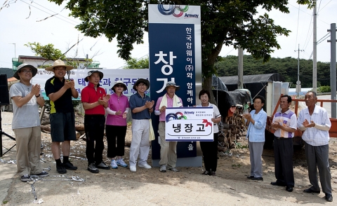 한국암웨이 박세준 대표이사(왼쪽에서 여섯번 째)와 임직원들이 태안군 창기 6리 주민들과 ‘태안군과 친구되기’ 결연을 기념하는 제막식을 갖고 있다.