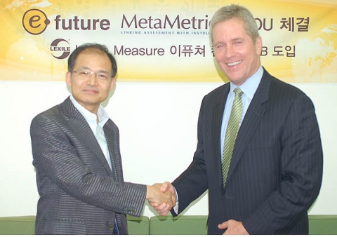 CEO Gyeong-Ho Hwang of E-Future shakes hands with President Malbert Smith of MetaMetrics after signi...