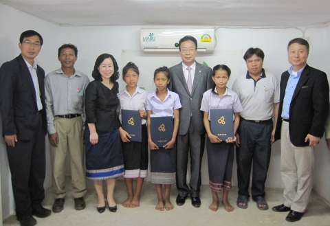 라오스를 방문한 녹색사업단 장찬식 단장(가운데)이 지난 9일, 비엔티안 쌍통구(Sangtong District) 마루산업 김지영 사장(왼쪽 세번째) 조림지 사무실에서 가정 형편이 어려운 라오스 어린이들에게 장학금과 증서를 전달하고 기념사진을 촬영했다.