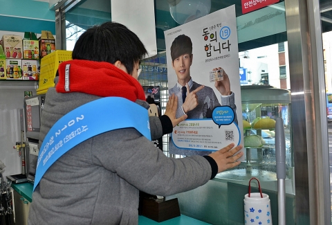 ‘청소년흡연예방캠페인’ 대학생 서포터즈가 9일 서울 서대문구 충정로의 한 편의점에 담배 구입 시 신분증을 제시하고 확인하는 절차를 생활화해 청소년 흡연을 미연에 예방하자는 내용의 포스터를 부착하고 있다.