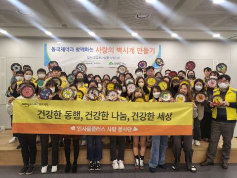 동국제약 임직원들이 사랑의 벽시계 봉사 활동 후 기념 촬영을 하고 있다