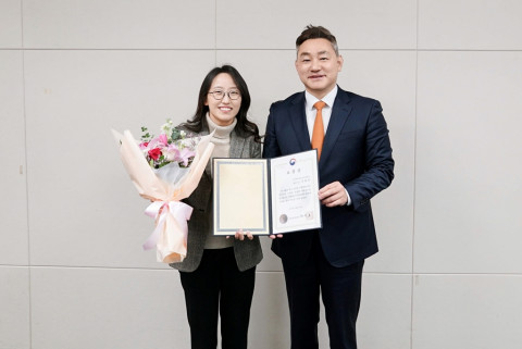 사이버한국외대 장지호 총장(오른쪽)이 사이버대학 발전 유공 표창 수상자인 이화진 입학팀장(왼쪽)에게 표창장을 전달한 뒤 기념촬영을 하고 있다