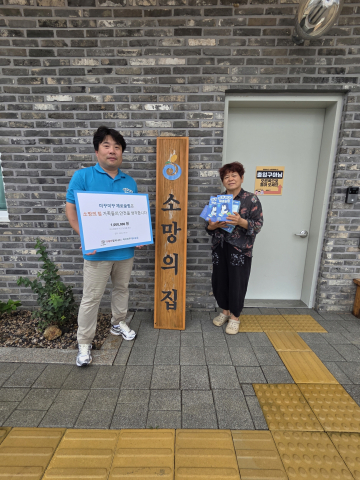 왼쪽부터 더제이컴퍼니 김성광 과장이 소망의집 박현숙 대표와 기념 촬영을 하고 있다(더제이컴퍼니 제공)