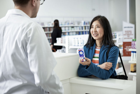 A pharmacist advises a consumer on the purchase of Haleon’s Otrivin nasal mist.
