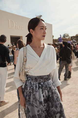 디올 컬렉션 현장에서 포착된 배선영. 화이트 랩 블라우스와 플로럴 스커트로 모던 한복 실루엣을 세련되게 풀어냈다