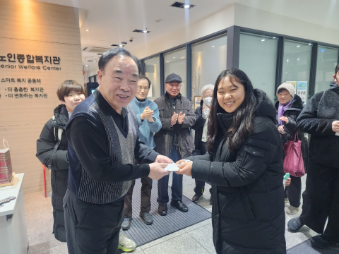 청소년들이 지역 복지관 어르신께 핫팩을 전달하고 있다