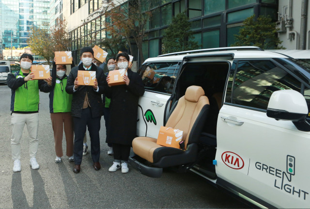 스낵24 김대현 이사와 초록여행 직원들이 초록여행 차량 앞에서 기념 촬영을 하고 있다