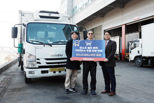 이스즈 ‘엘프’ 트럭을 누적 100만km 운행한 유남식 씨(가운데)가 이를 기념하는 행사에서 큐로모터스 김석주 대표이사(오른쪽)와 함께 기념 촬영을 하고 있다