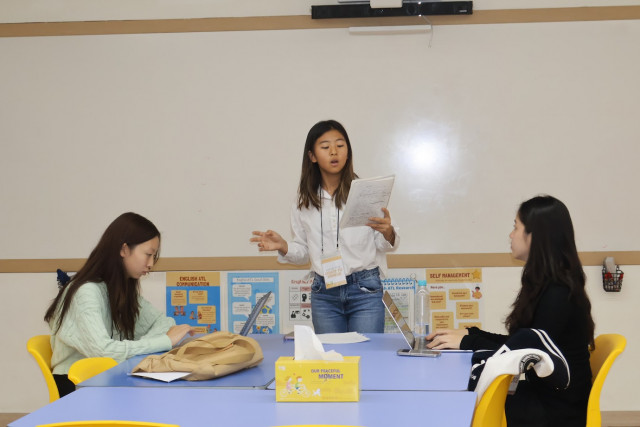 Students are actively engaging in debates on various topics in front of judges.