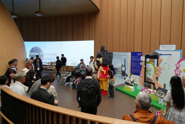 Visitors take photos and interact with Hytera&#039;s mascot during the Theme Day on May 11 at the China Pavilion.