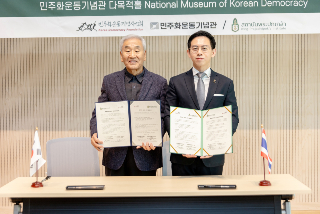 이재오 민주화운동기념사업회 이사장(왼쪽)과 이사라 세레따나웃 KPI 사무총재가 업무협약서 서명을 마치고 기념사진 촬영을 하고 있다
