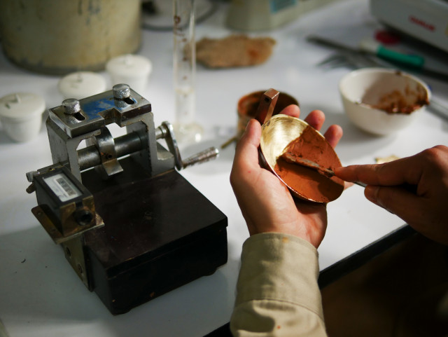 A lab technician is pictured conducting an Atterberg limits test. Geotechnical labs can generate Atterberg limits test certificates from raw lab test data in OpenGround. Atterberg limits tests reveal soil behaviour under moisture changes, guiding geotechnical engineers in soil classification and foundation design for civil infrastructure projects.