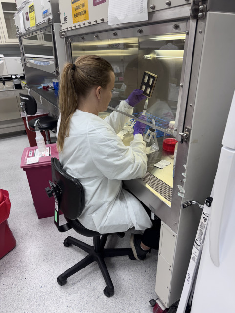 Rachel Nordberg, PhD, from the DELTAi Lab at UC Irvine, prepping the BioServe device before it goes into orbit.