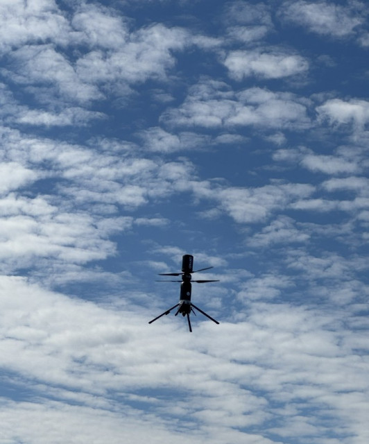 Dryad Silvaguard Observation Drone flying. The drone can autonomously fly to a wildfire detected by a Silvanet Wildfire Sensor and precisely geolocate the fire with infrared sensors.