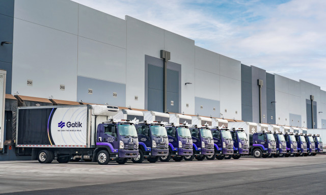 A fleet of Gatik's autonomous trucks at a customer distribution center