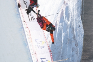 프리스타일 스키 선수가 하프파이프에서 연기동작을 하고 있다.