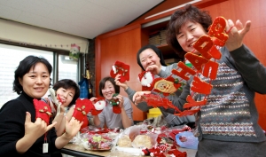 서울장애인종합복지관 직원과 자원봉사자들이 성탄 장식물들을 손보며 환하게 웃어 보이고 있다.