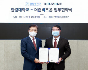 왼쪽부터 최양희 한림대학교 총장과 김용우 더존ICT그룹 회장이 협약서를 교환하고 기념촬영을
