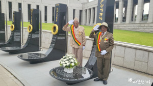 한국에 초청된 에티오피아 참전용사가 용산전쟁기념관에서 에티오피아 참전자 명비에 헌화하고, 경례하고 있다